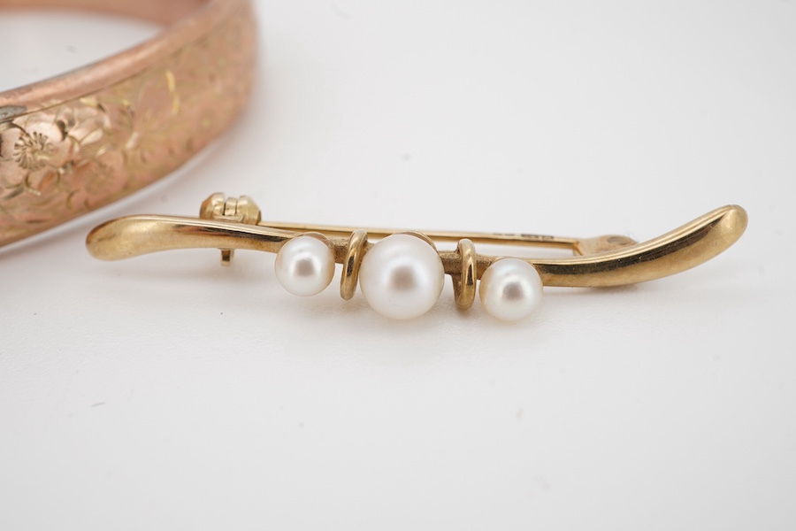 A George V 9ct gold bangle, a 375 and cultured pearl bar brooch,37mm, a modern 9ct gold and three stone diamond set small pendant and a 9ct sweetheart RAF brooch, gross weight 15.5 grams. Condition - poor to fair